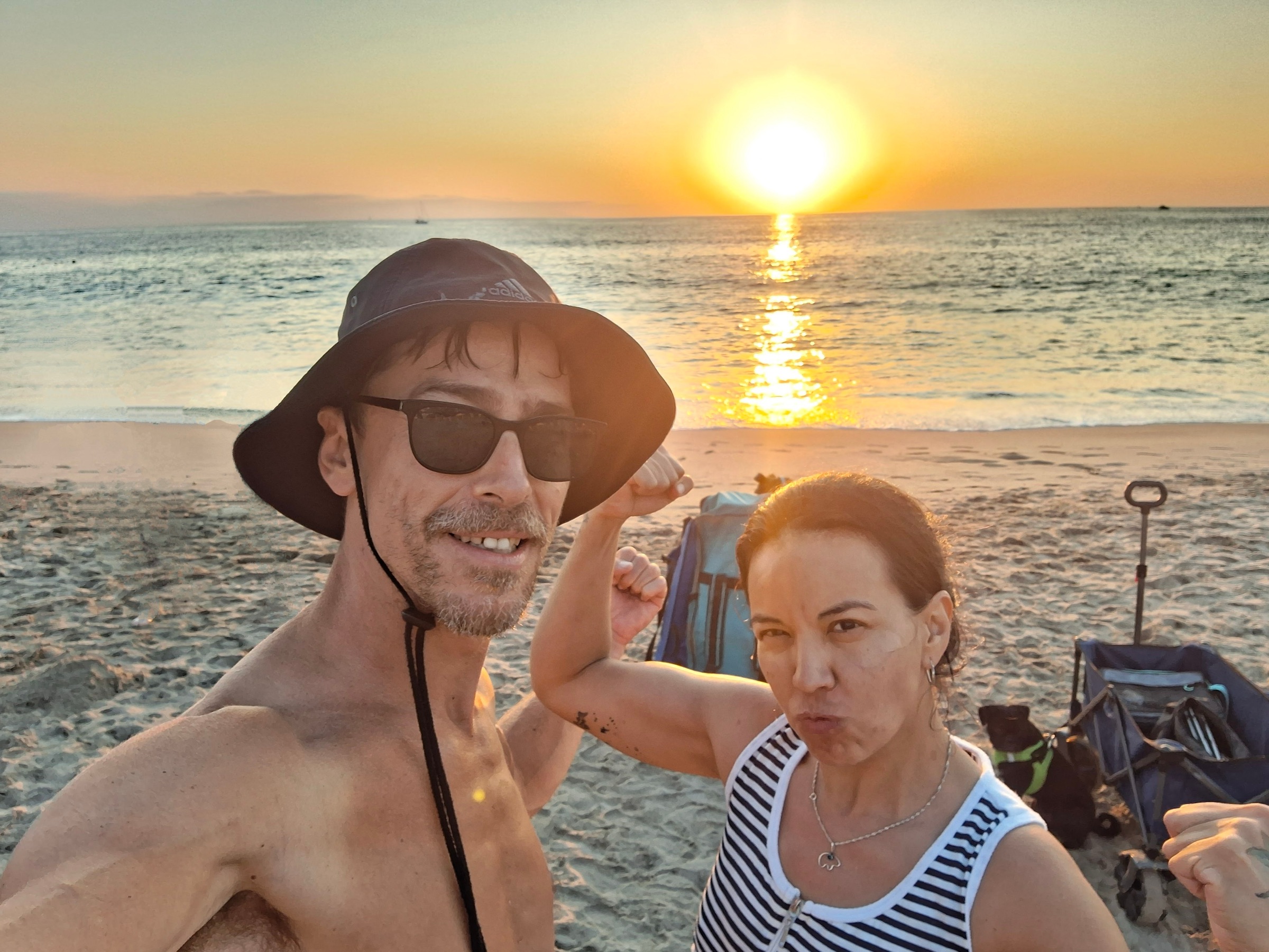 Brent and his wife on the beach at sunset after a paddle board session